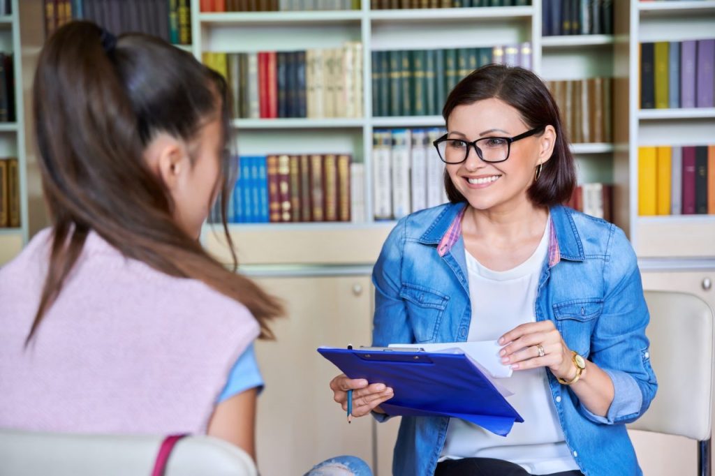 Woman School Psychologist Teacher Social Worker Mentor Working With Teenage Girl 1 1